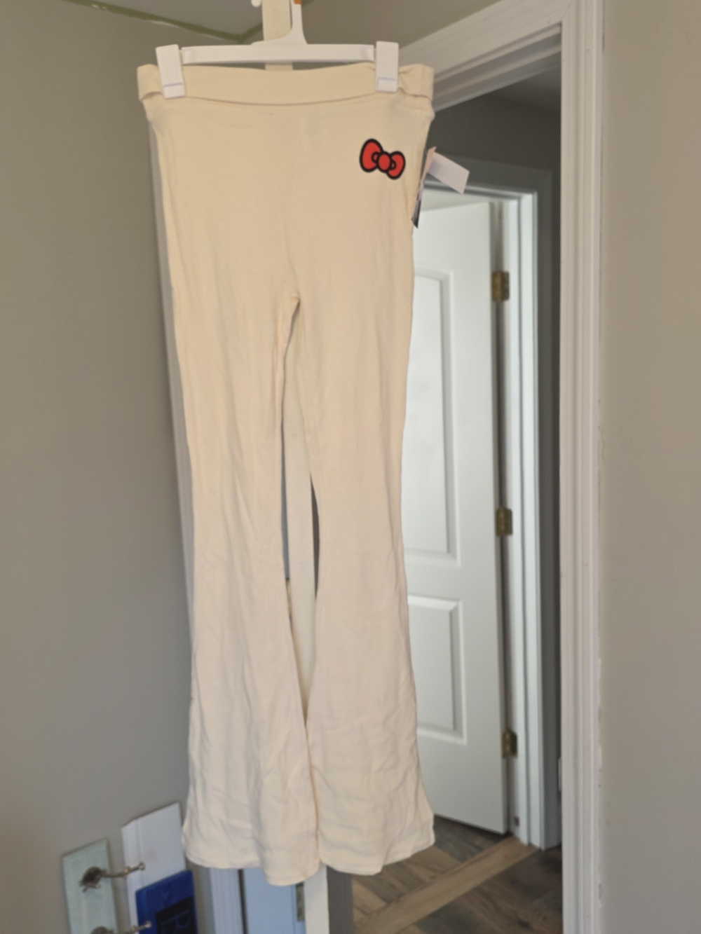 Hello Kitty Cream Flared Leggings with Red Bow Accent
